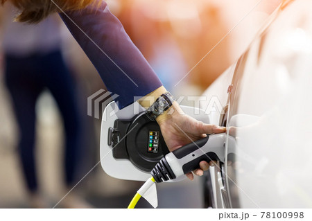 Hand holding Electric car charger.  78100998