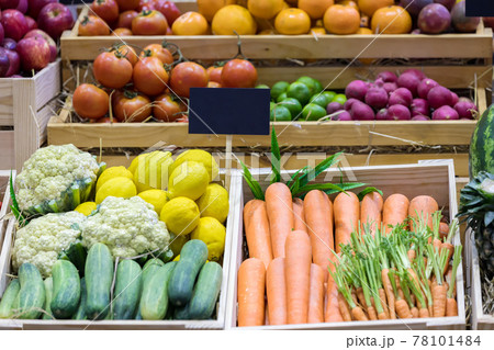 Fresh fruits at a market. Fruit stall in the city market. Fruits in baskets on market place. 78101484