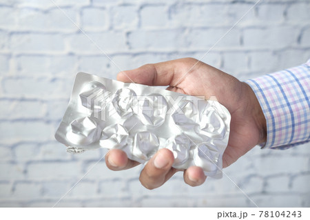 Close up of hand holding blister packs . 78104243