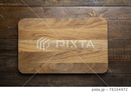 Empty rectangular cutting board on a wooden table. Space for text. 78104972