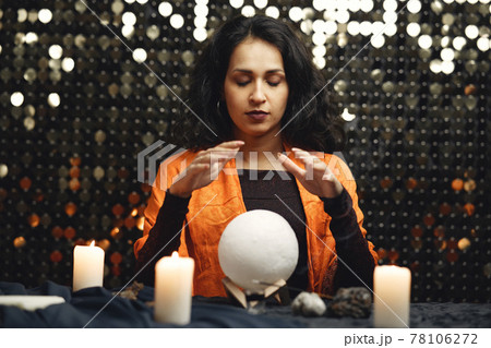 Portrait of fortune-teller in a dark room 78106272