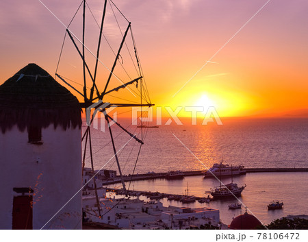 Famous traditional Greek windmill, Mykonos, Greece against sunset and sea. Beautiful sky, sun touch sea horizon, colorful image, selective focus Famous traditional Greek windmill, Mykonos, Greece against sunset and sea. Beautiful sky, sun touch sea horizon, colorful image, selective focus 78106472