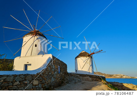 Famous tourist attraction, Mykonos, Greece. Two traditional whitewashed windmills. Summer, morning, clear blue sky, travel destination, iconic view. 78106487