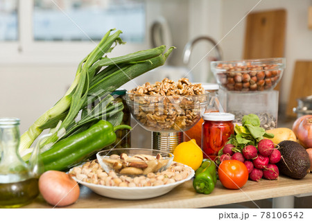 Vegetables and nuts on kitchen table Vegetables and nuts on kitchen table 78106542