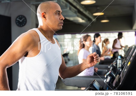 Man training on treadmill at fitness center Man training on treadmill at fitness center 78106591