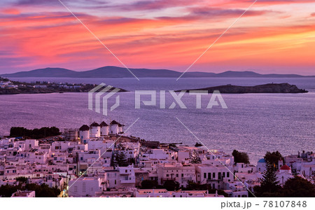 Beautiful sunset view, famous traditional white windmills on hilltop, Mykonos, Greece. Whitewashed house, summer, iconic Mediterranean destination 78107848