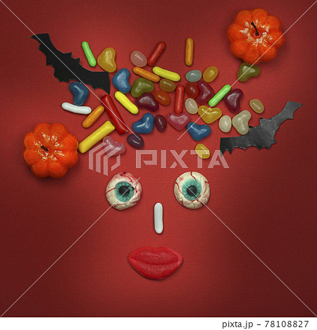 Halloween composition, female face made of pumpkins,sweets,bats  78108827