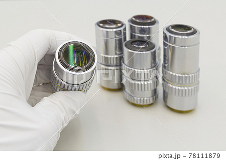Detail of microscope lens on an white background.Closeup of microscope objectives. Detail of microscope lens on an white background.Closeup of microscope objectives. 78111879