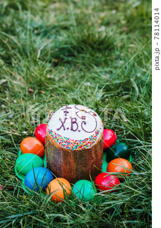 painted and decorative Easter cake and eggs in the grass. Top view, copy space painted and decorative Easter cake and eggs in the grass. Top view, copy space 78114014