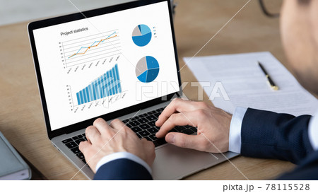 Business leader analyzing financial sales report, reviewing marketing research 78115528