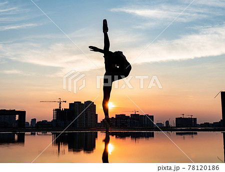 Silhouette of ballerina performing outdoor during sunset. Concept of willpower, motivation and desire Silhouette of ballerina performing outdoor during sunset. Concept of willpower, motivation and desire 78120186