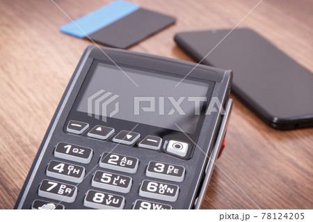 Payment terminal with credit card and mobile phone. Cashless paying for shopping. Finance concept 78124205