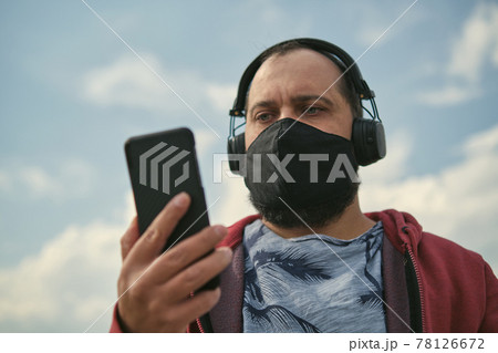Middle aged man listening to music, close up Middle aged man listening to music, close up 78126672