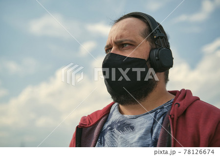 Middle aged man listening to music, close up Middle aged man listening to music, close up 78126674