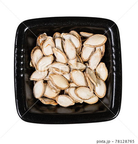 whole pumpkin seeds in black bowl isolated whole pumpkin seeds in black bowl isolated 78128765