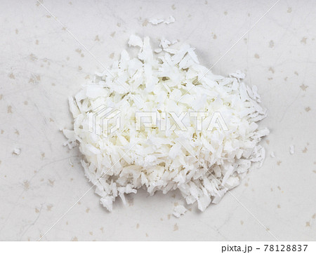 pile of coconut flakes close up on gray 78128837