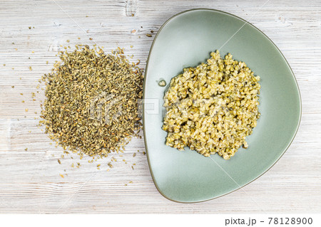 top view of raw freekeh wheat grains and porridge 78128900