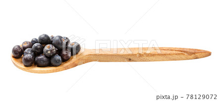 wooden spoon with dried juniper berries isolated 78129072
