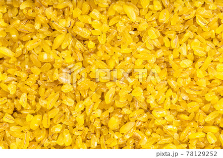 background - uncooked bulgur wheat groats background - uncooked bulgur wheat groats 78129252