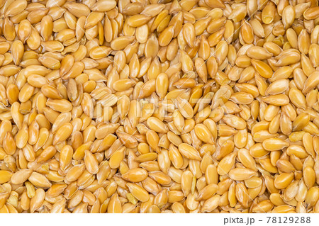 background - many golden flax seeds 78129288