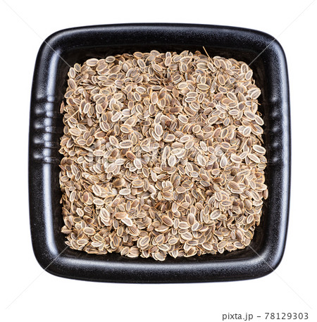 dried dill seeds in black bowl isolated 78129303