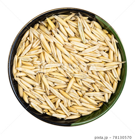unhulled common oat grains in round bowl isolated unhulled common oat grains in round bowl isolated 78130570