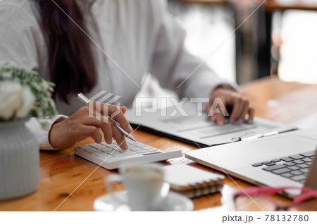 Close up woman using computer calculating finance or taxes on machine, female manage home family expenditures, using calculator, make payment on laptop Close up woman using computer calculating finance or taxes on machine, female manage home family expenditures, using calculator, make payment on laptop 78132780