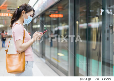 woman with mask in station woman with mask in station 78133599