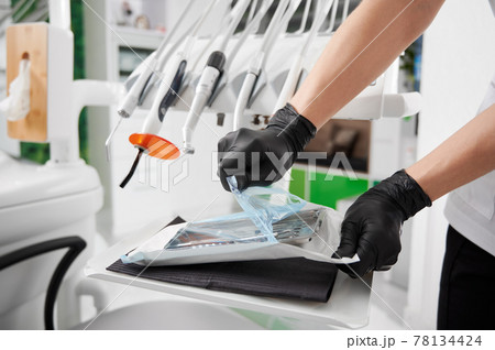 Dentist opening package with sterile dental instruments. Dentist opening package with sterile dental instruments. 78134424