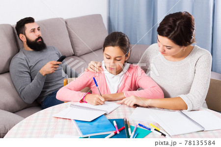 Mother helping child to do homework Mother helping child to do homework 78135584
