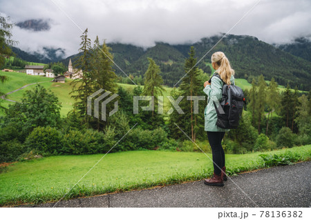 Woman enjoy the view of Val di Funes valley in the Dolomites, Santa Maddalena touristic village, Dolomites, Italy, Europe 78136382