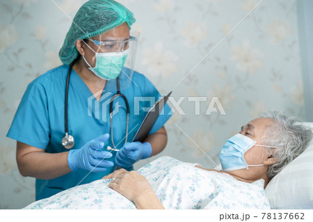 Asian doctor wearing face shield and PPE suit new normal to check patient protect safety infection Covid-19 Coronavirus outbreak at quarantine nursing hospital ward. Asian doctor wearing face shield and PPE suit new normal to check patient protect safety infection Covid-19 Coronavirus outbreak at quarantine nursing hospital ward. 78137662