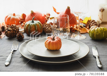 Halloween and Thanksgiving day dinner decorated fallen leaves, pumpkins, spices, grey plate. Halloween and Thanksgiving day dinner decorated fallen leaves, pumpkins, spices, grey plate. 78139388