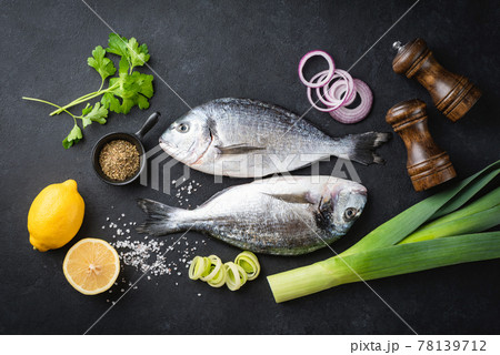 Uncooked dorado fish, spices and vegetables 78139712