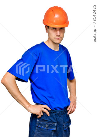 Studio portrait of a confident worker in a construction helmet looking at the camera and holding his 78142425