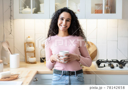 Home Relax. Portrait Of Happy Beautiful Lady Drinking Coffee In Kitchen Interior Home Relax. Portrait Of Happy Beautiful Lady Drinking Coffee In Kitchen Interior 78142658