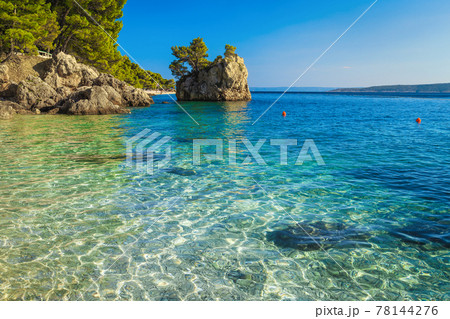 Small rock island and transparent sea in Dalmatia, Brela, Croatia 78144276