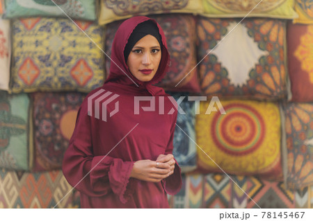 Arabian young muslim woman sitting in a cafe. Arabian young muslim woman sitting in a cafe. 78145467