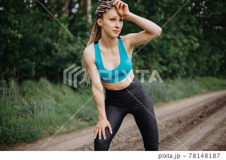 Fit woman wiping sweat after morning jogging Fit woman wiping sweat after morning jogging 78148187