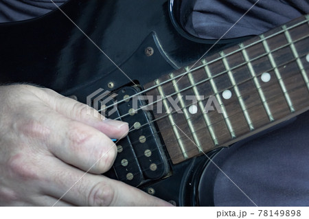 Close-up of man playing lead guitar solo 78149898