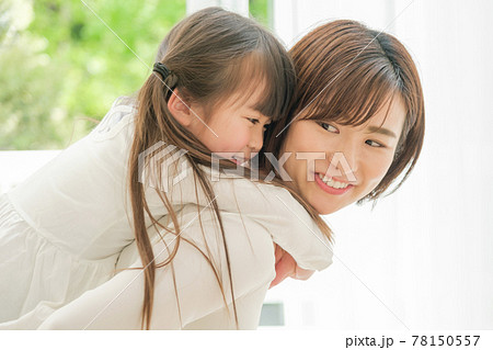 女の子をおんぶする女性の写真素材