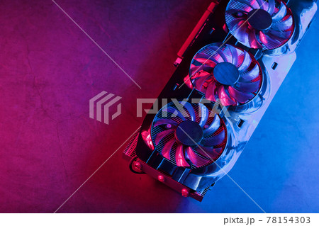 Gaming graphics card with neon magenta-cyan illumination and high-speed fans. Gaming graphics card with neon magenta-cyan illumination and high-speed fans. 78154303