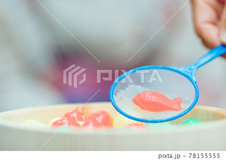 金魚すくいでおもちゃを釣る女性 金魚すくいでおもちゃを釣る女性 78155555