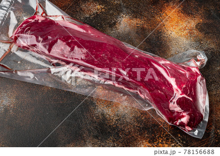 Fillet beef vacuum bag for sous vide, on old dark rustic background 78156688