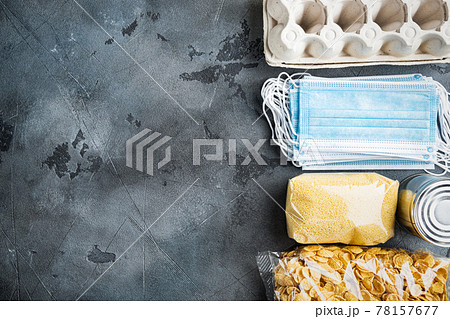 Various canned food and raw cereal grains, grocery goods for cooking, delivery or donation, flat lay with space for text, on grey background 78157677