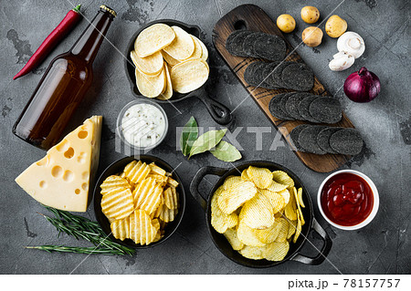Potato chips. Beer snacks, sauce with Cheese and Onion, with dipping sauces , on gray stone background, top view flat lay Potato chips. Beer snacks, sauce with Cheese and Onion, with dipping sauces , on gray stone background, top view flat lay 78157757