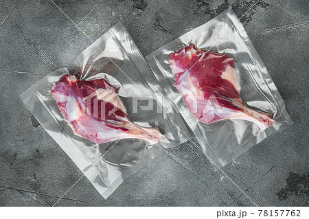 Duck organic leg meat vacuum sealed, on gray stone background, top view flat lay Duck organic leg meat vacuum sealed, on gray stone background, top view flat lay 78157762
