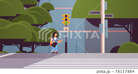 schoolgirl with backpack waiting for green traffic light to cross road on crosswalk road safety concept cityscape 78157864