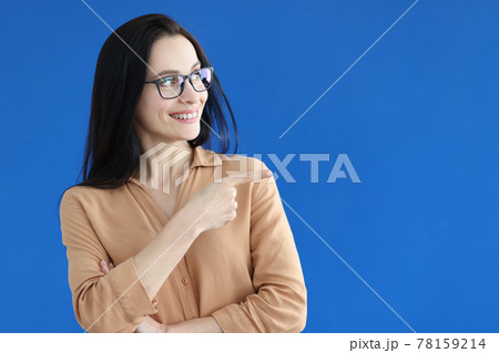 Beautiful smiling woman with glasses gestures to advertisement Beautiful smiling woman with glasses gestures to advertisement 78159214