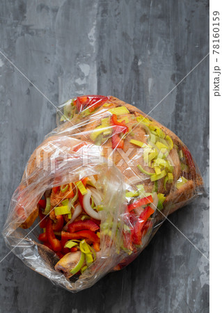 chicken with herbs, red pepper, onion in plastic bag for cook chicken with herbs, red pepper, onion in plastic bag for cook 78160159